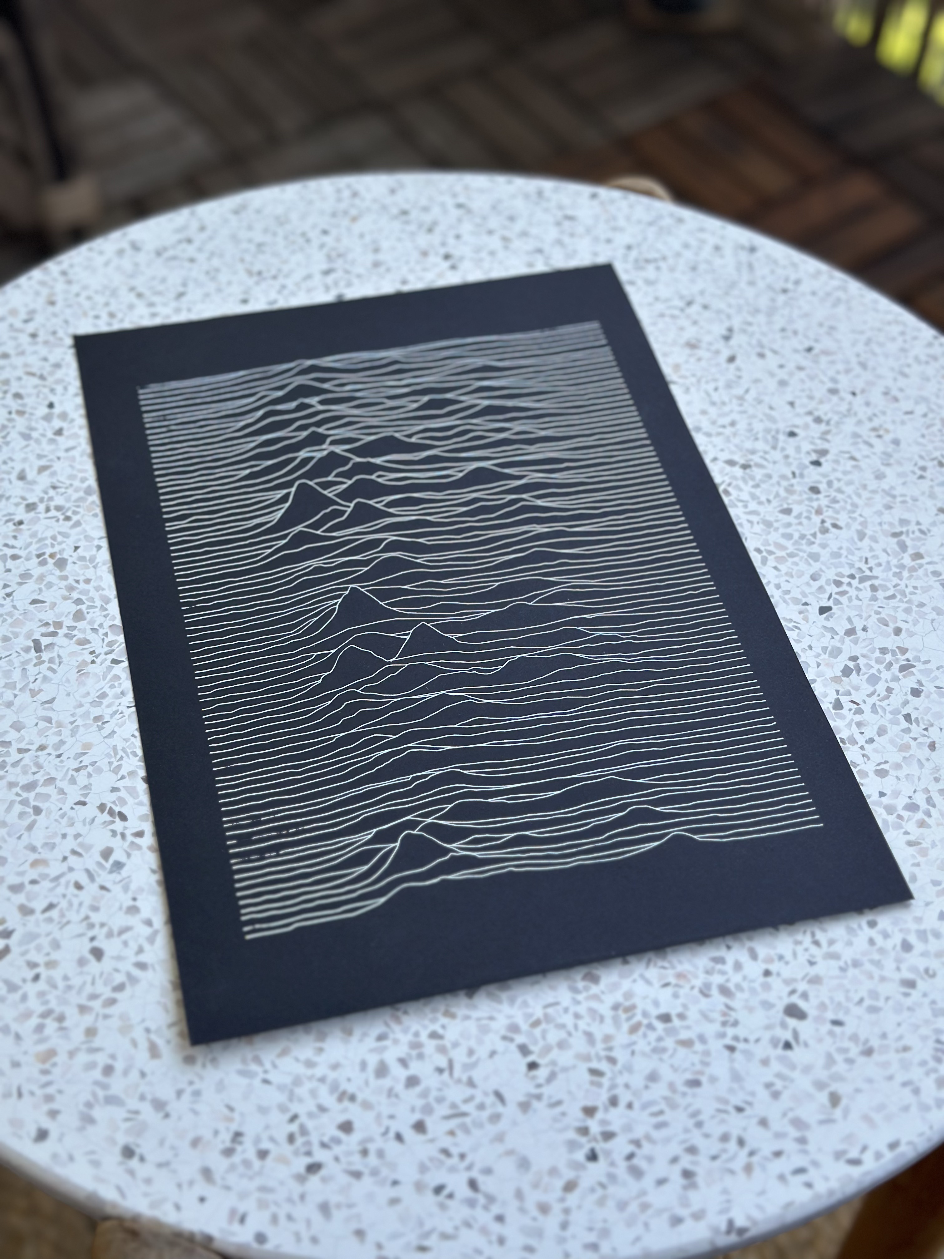 Unknown Pleasures pen plot on black paper, side angle view